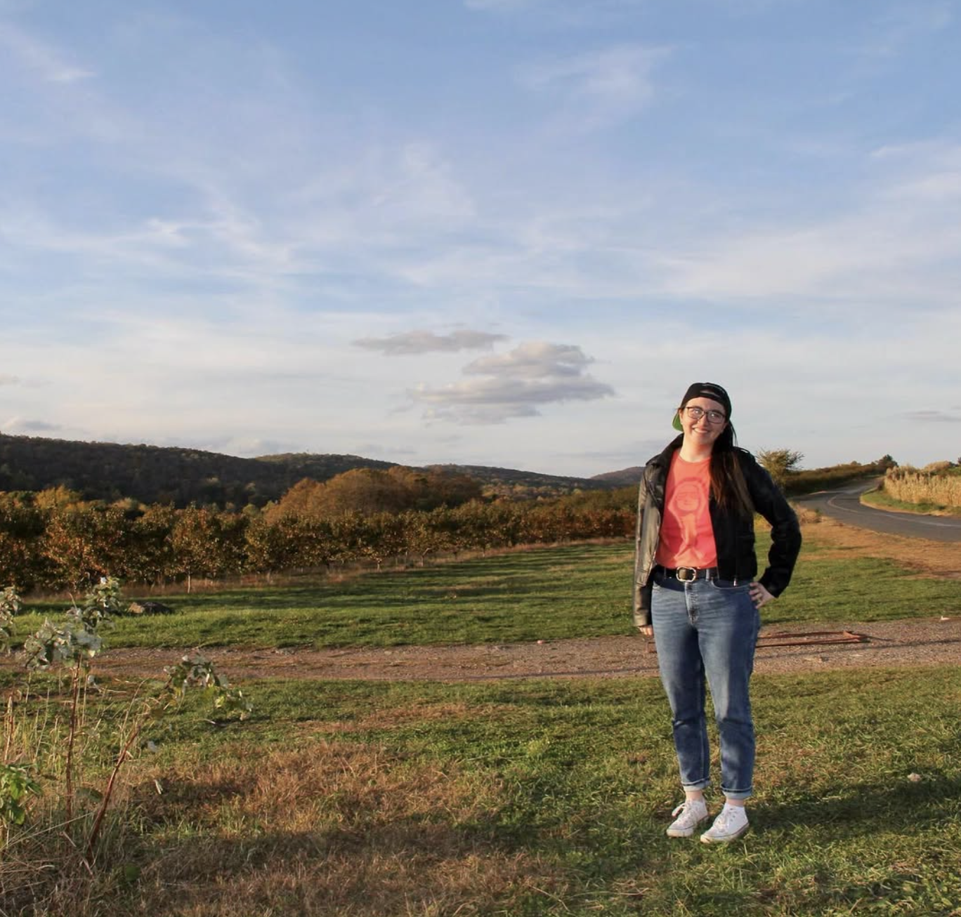 Monica Chin outdoors at an orchard at golden hour